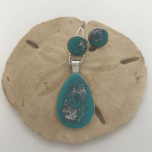 Turquoise and silver colored necklace and earrings set